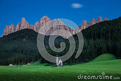 Tiny Church of San Giovanni in South Tyrolâ€™s Val di Funes in front of Dolomite mountain Stock Photo